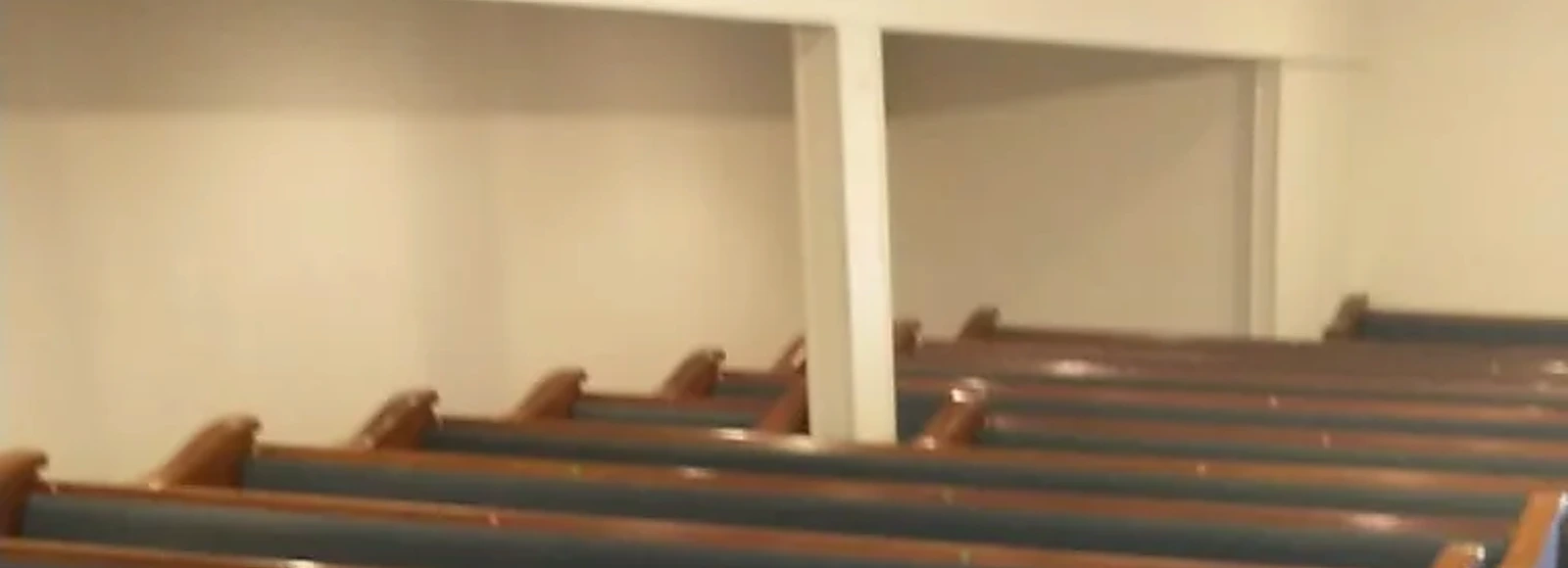 Wide detail of sanctuary pews during the verified church interior renovation