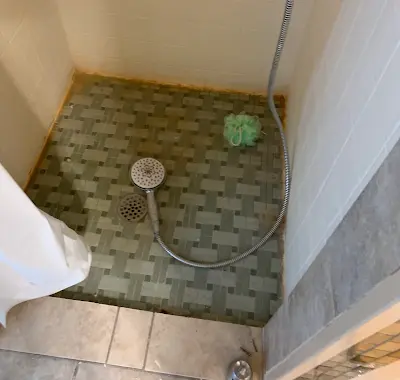 Finished shower floor in a shared-housing conversion