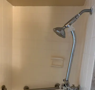Completed shower fixture in a shared-housing conversion